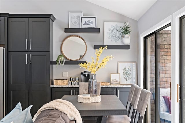 dining room featuring lofted ceiling