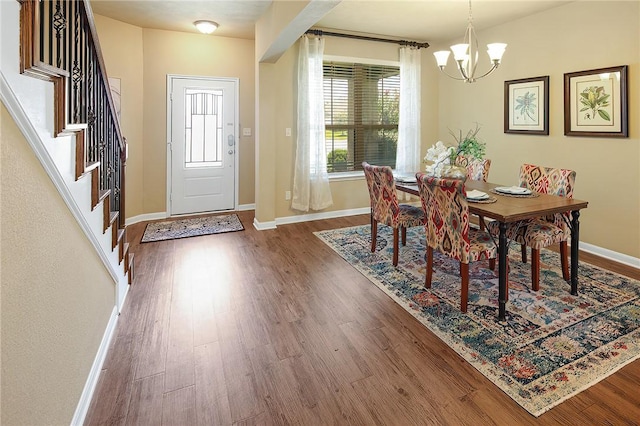 dining room with an inviting chandelier and dark hardwood / wood-style flooring