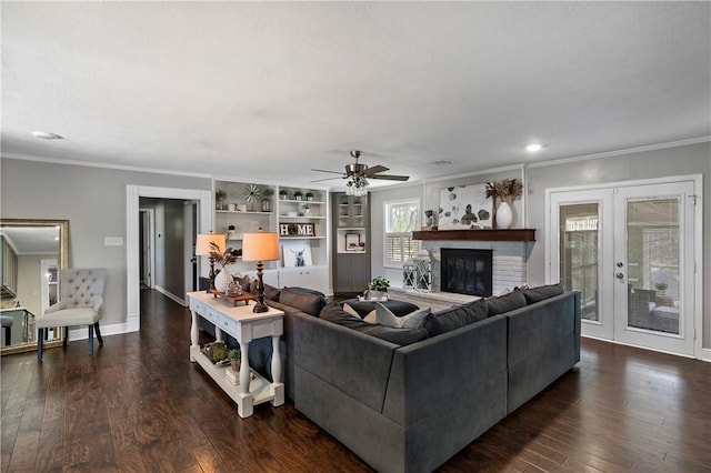 living room featuring dark wood-style floors, baseboards, ceiling fan, french doors, and crown molding