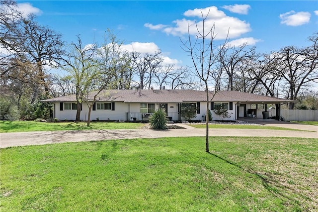 ranch-style house featuring driveway, an attached carport, a front lawn, and fence