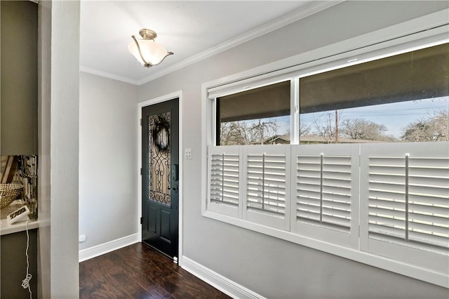 foyer entrance with baseboards, wood finished floors, and crown molding