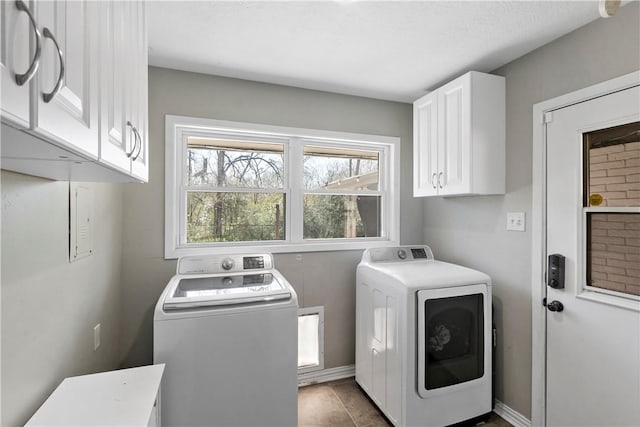 laundry room with baseboards, cabinet space, and independent washer and dryer