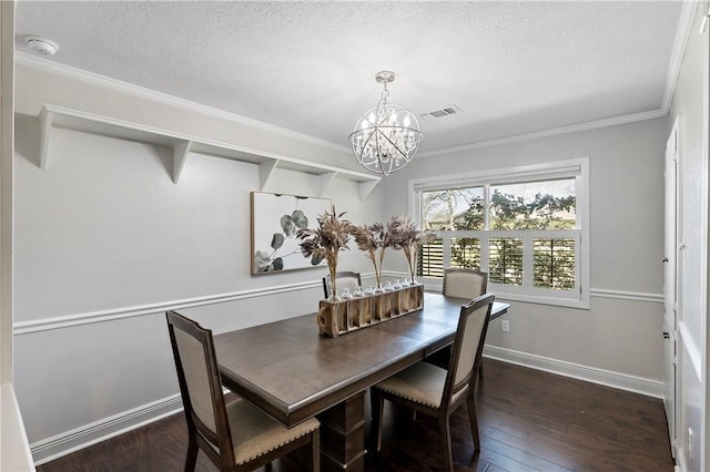 dining area featuring a textured ceiling, crown molding, dark wood-style flooring, and a chandelier