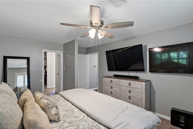 bedroom with visible vents, a ceiling fan, and baseboards