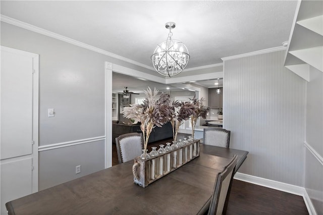 dining space featuring an inviting chandelier, wood finished floors, baseboards, and ornamental molding