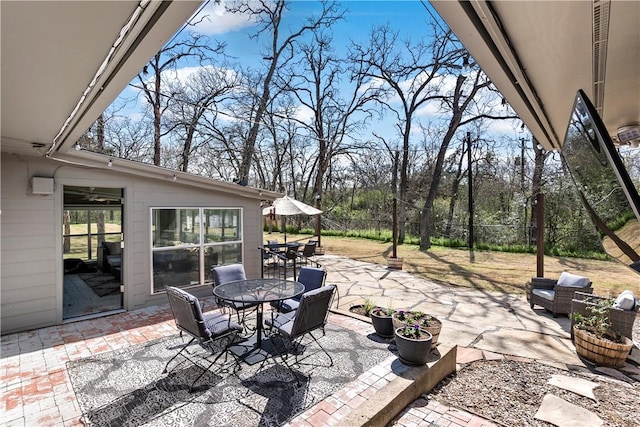 view of patio / terrace featuring outdoor dining space and fence