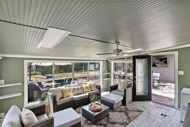 sunroom / solarium featuring ceiling fan