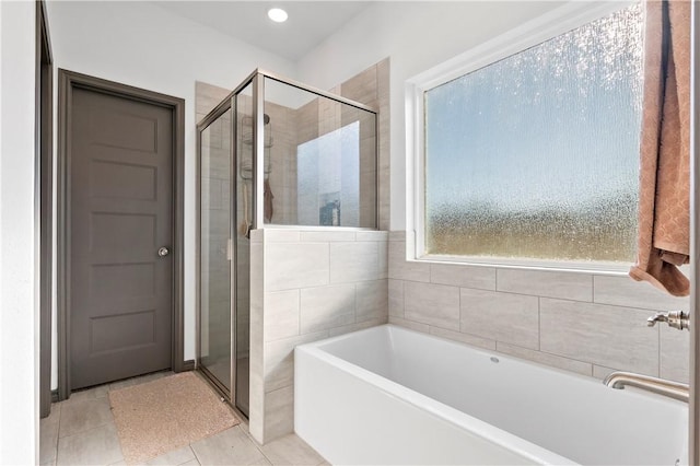 bathroom featuring tile patterned flooring and independent shower and bath