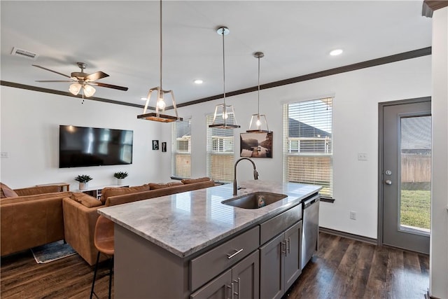 kitchen featuring dishwasher, a center island with sink, sink, hanging light fixtures, and ornamental molding