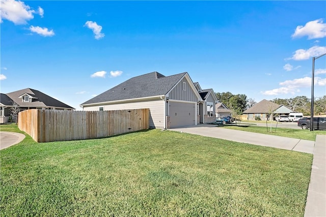 view of home's exterior featuring a lawn and a garage