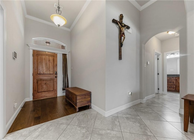 8305 Raintree Dr, College Station, TX 77845 - foyer with arched walkways, crown molding, and baseboards