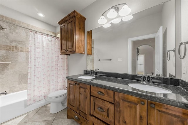 8305 Raintree Dr, College Station, TX 77845 - bathroom featuring toilet, double vanity, tile patterned floors, and shower / bath combo