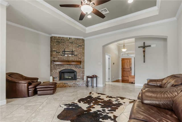 8305 Raintree Dr, College Station, TX 77845 - living area with a tray ceiling, arched walkways, a ceiling fan, crown molding, and baseboards