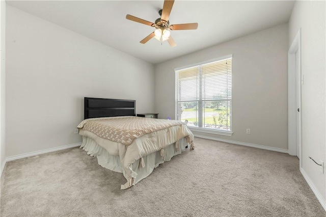 8305 Raintree Dr, College Station, TX 77845 - carpeted bedroom with baseboards and a ceiling fan