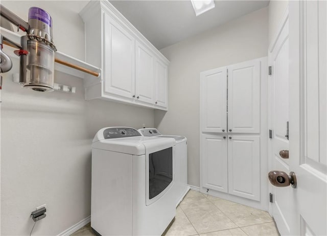 8305 Raintree Dr, College Station, TX 77845 - laundry room with independent washer and dryer, cabinet space, light tile patterned flooring, and baseboards