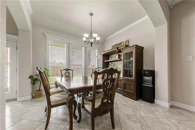 8305 Raintree Dr, College Station, TX 77845 - dining space featuring arched walkways, a chandelier, baseboards, light tile patterned flooring, and crown molding