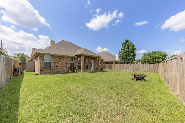 8305 Raintree Dr, College Station, TX 77845 - view of yard featuring an outdoor fire pit