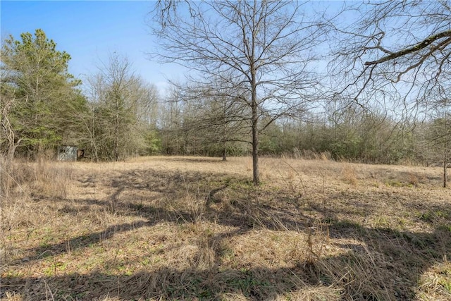 view of landscape with a forest view