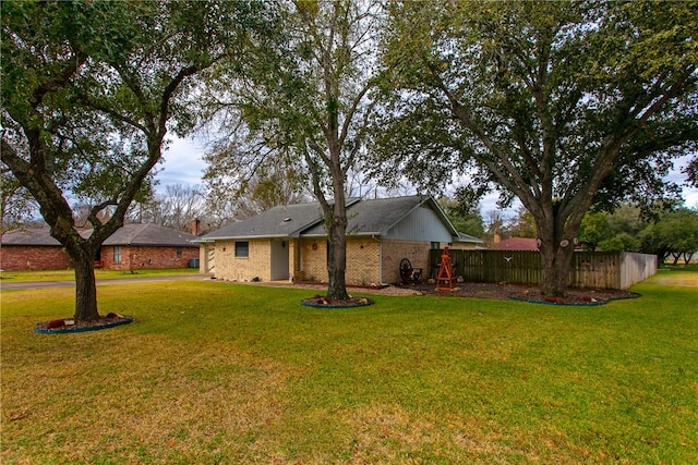 view of front of property featuring a playground and a front lawn