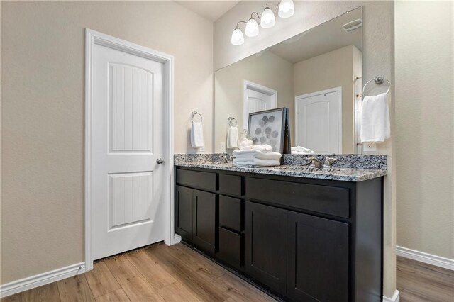 bathroom with vanity and hardwood / wood-style flooring