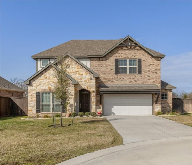 view of front of house featuring a garage and a front lawn