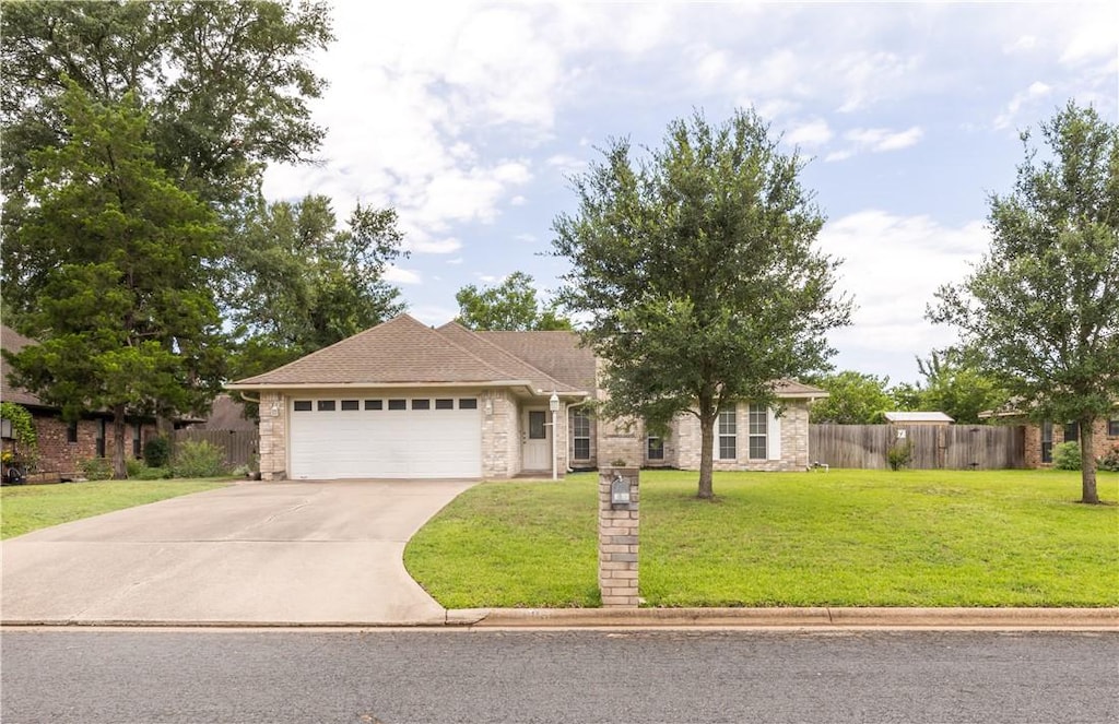 2908 Rayado Ct S, College Station, TX 77845 - ranch-style home with an attached garage, driveway, and stone siding
