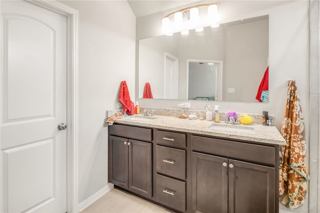7906 Putter Pl, Navasota, TX 77868 - bathroom with double vanity, baseboards, and tile patterned floors