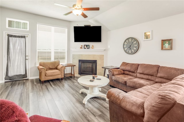 7906 Putter Pl, Navasota, TX 77868 - living room featuring a ceiling fan, a fireplace, wood finished floors, baseboards, and vaulted ceiling