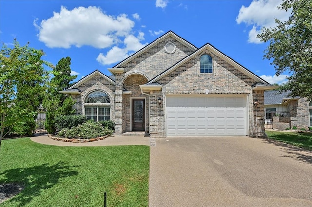 french country style house featuring brick siding, driveway, and a front lawn