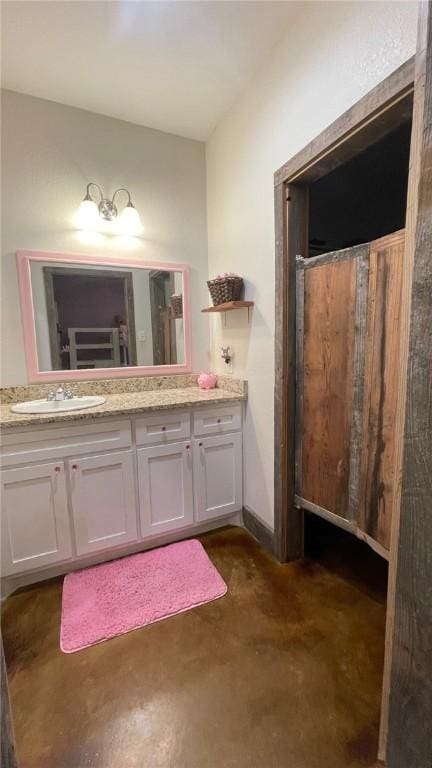 bathroom with vanity and concrete floors