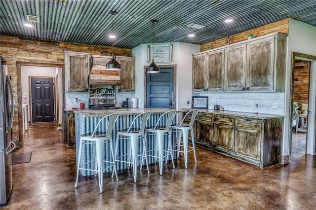 1850 Lcr 439, Groesbeck, TX 76667 - kitchen featuring concrete floors, appliances with stainless steel finishes, a kitchen island, light stone counters, and recessed lighting