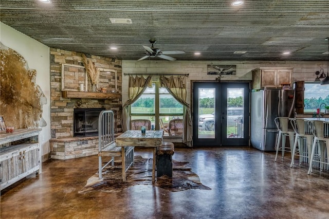 1850 Lcr 439, Groesbeck, TX 76667 - dining area with concrete flooring, ceiling fan, french doors, a fireplace, and recessed lighting