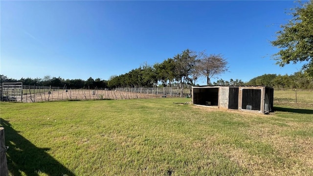 view of yard featuring an outbuilding and a rural view