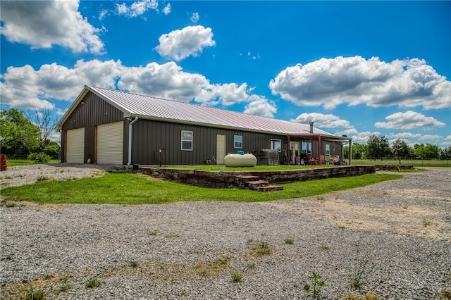 1850 Lcr 439, Groesbeck, TX 76667 - view of front of house featuring an outdoor structure, metal roof, board and batten siding, and a detached garage