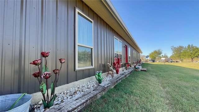 view of property exterior with a yard