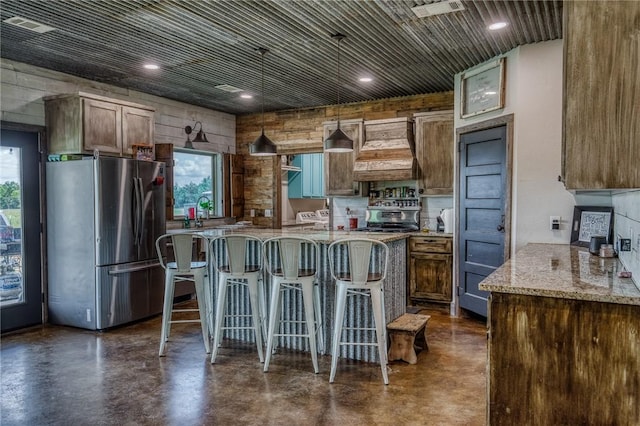 1850 Lcr 439, Groesbeck, TX 76667 - kitchen featuring freestanding refrigerator, concrete floors, premium range hood, a center island, and light stone counters