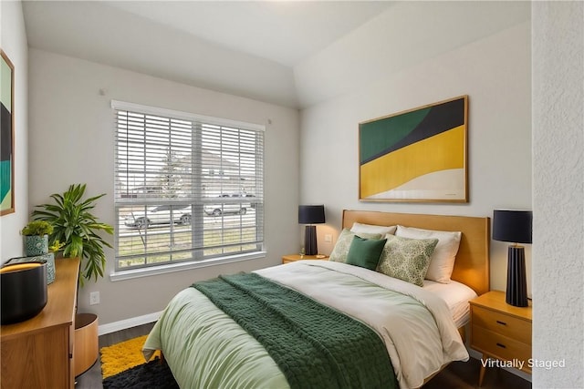 bedroom featuring baseboards and wood finished floors