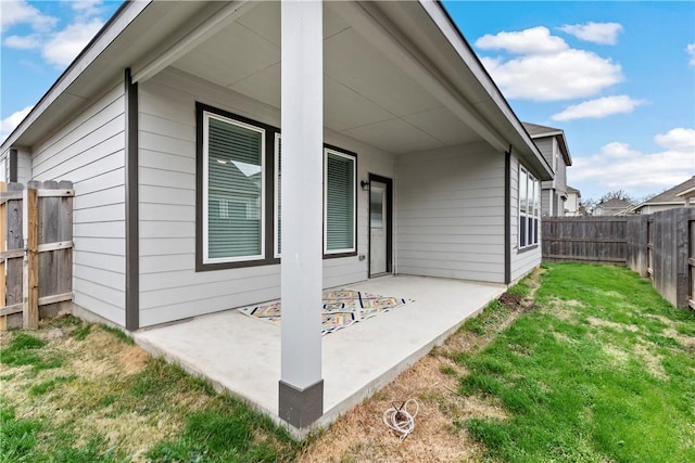 exterior space featuring a lawn, a patio area, and fence private yard