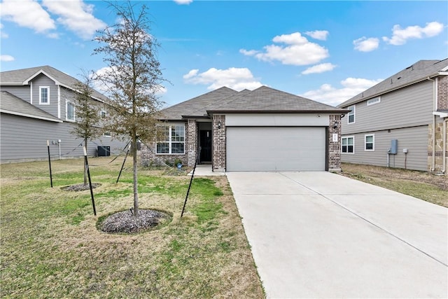 view of front of home with a front yard, brick siding, and an attached garage