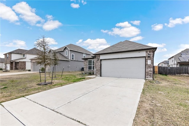 view of front of house with brick siding, a front yard, a garage, a residential view, and driveway