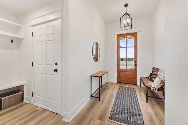 mudroom featuring a notable chandelier and light wood-type flooring