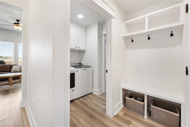 mudroom with ceiling fan, washer and dryer, and light hardwood / wood-style floors