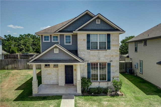 view of front of property with a patio area, a front yard, fence, and cooling unit