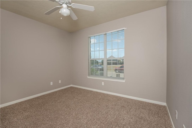 unfurnished room with carpet, ceiling fan, and baseboards