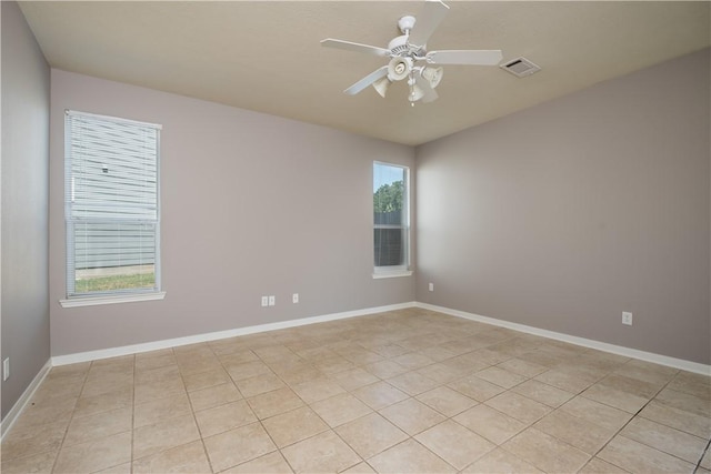 unfurnished room with visible vents, ceiling fan, baseboards, and light tile patterned floors