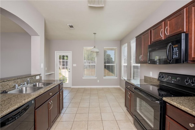 kitchen with decorative light fixtures, visible vents, light tile patterned flooring, a sink, and black appliances