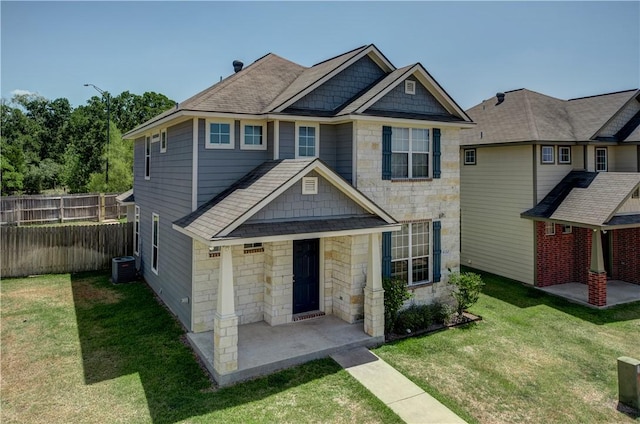 view of front facade with central AC unit, fence, a patio, and a front yard