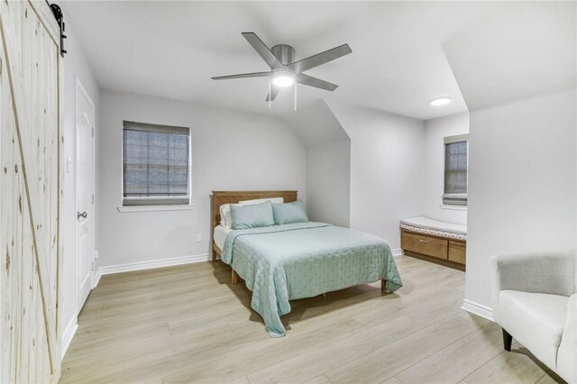 bedroom featuring baseboards, ceiling fan, and light wood-style flooring
