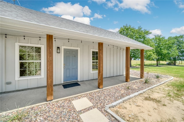 property entrance featuring board and batten siding, a porch, and a shingled roof