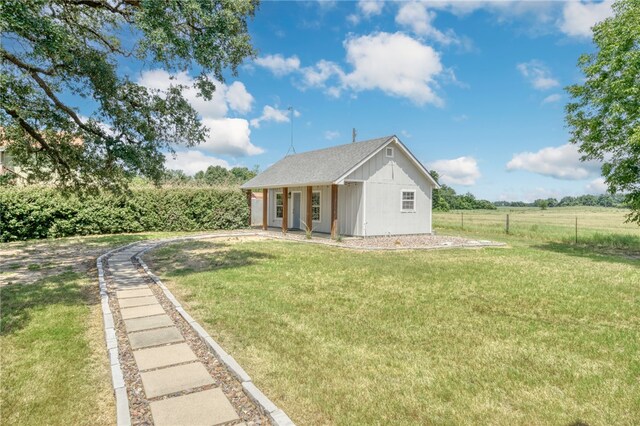exterior space featuring fence and a lawn